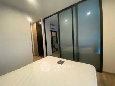 Modern bedroom with sliding glass doors and minimalist design