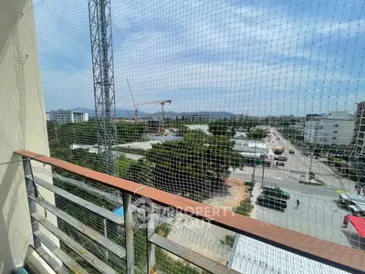 Scenic balcony view with construction and cityscape in the background.