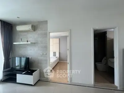 Modern apartment interior with living room, bedroom, and bathroom, featuring sleek design and natural light.
