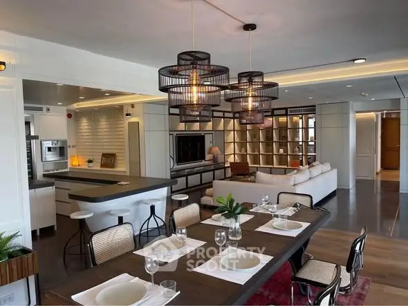 Luxurious open-plan living and dining area with modern lighting and stylish decor.