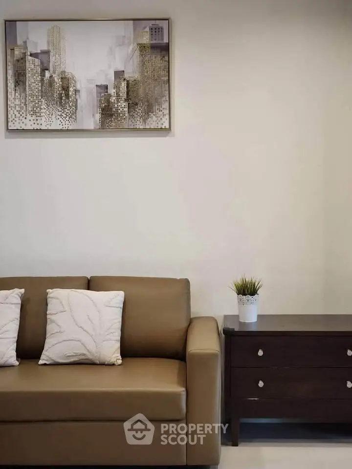 Modern living room with stylish sofa, artwork, and elegant decor