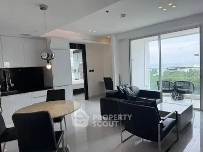 Modern open-plan living room with sleek kitchen and stunning balcony view.