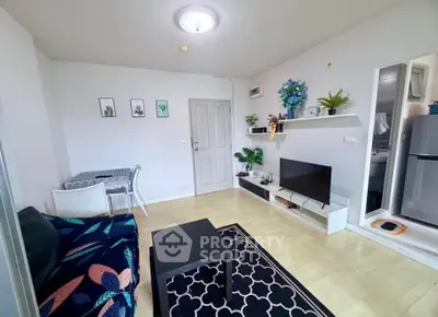 Charming living room with modern decor, cozy seating, and stylish shelving in a bright apartment.