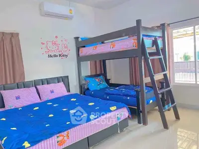 Charming bedroom with bunk bed and Hello Kitty decor, perfect for kids.