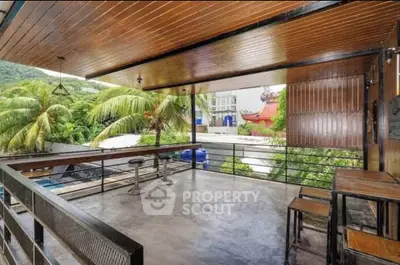 Spacious balcony with tropical view and modern seating, perfect for relaxation and entertainment.
