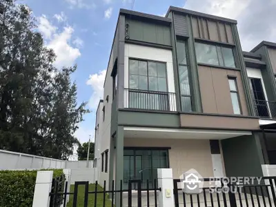 Modern townhouse exterior with sleek design and large windows in a serene neighborhood.