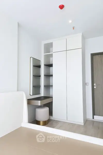 Modern bedroom with sleek white wardrobe and minimalist decor