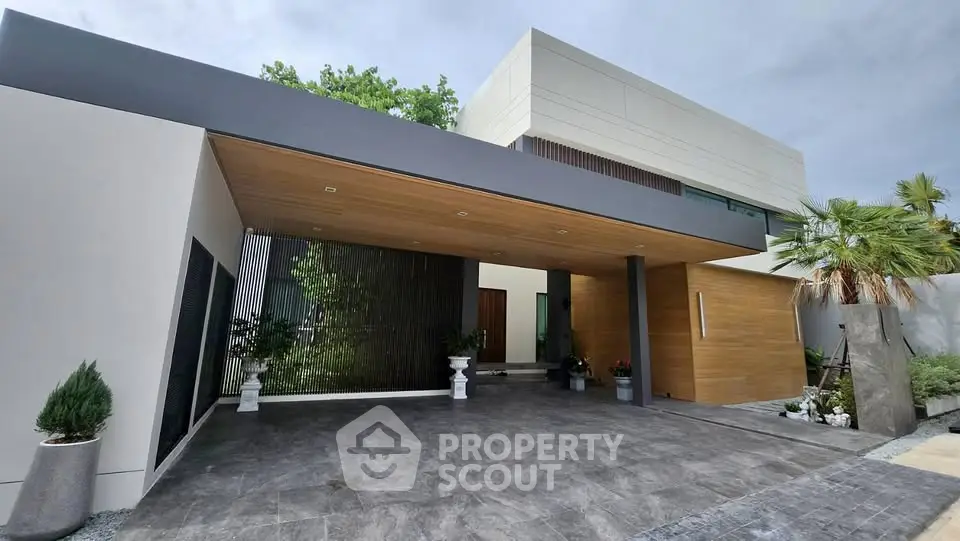 Modern luxury home exterior with sleek design and spacious driveway, featuring elegant landscaping and contemporary architecture.