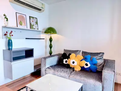 Stylish living room with modern decor and plush sofa in a cozy apartment setting.