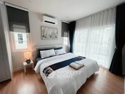 Modern bedroom with large windows and elegant decor in a stylish apartment