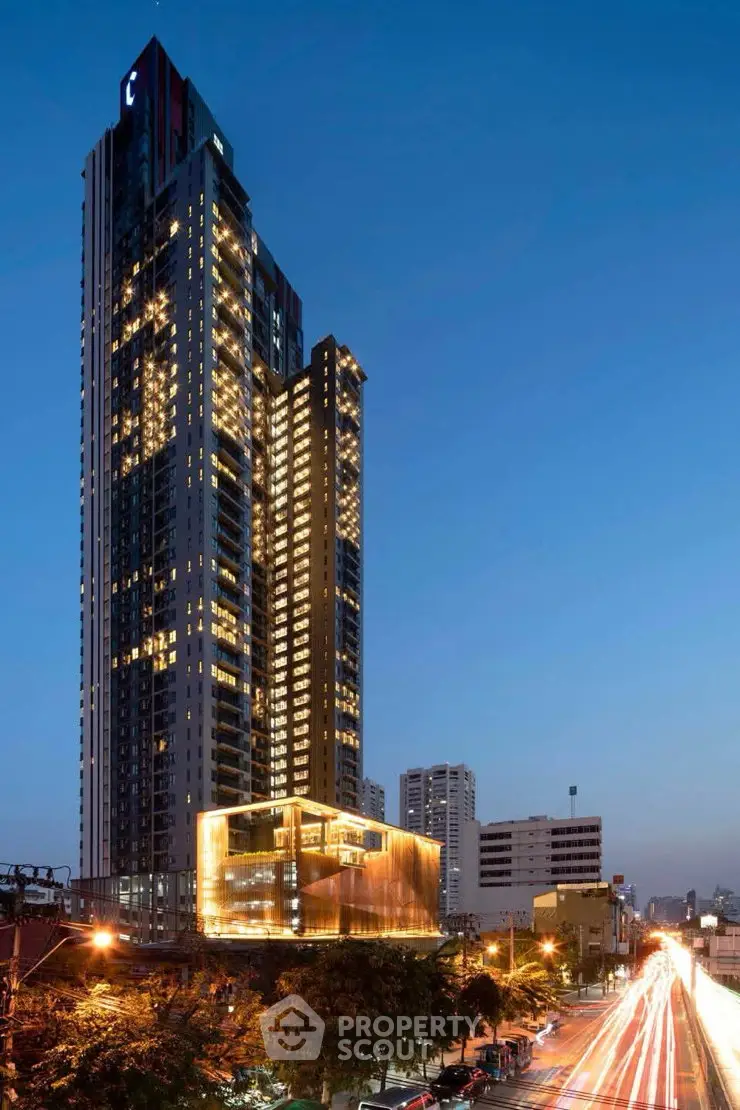 Stunning high-rise building with illuminated facade and vibrant cityscape view at dusk.