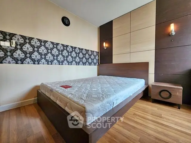 Modern bedroom with stylish decor and wooden flooring