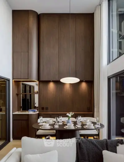 Luxurious modern dining area with high ceilings and elegant wooden paneling.