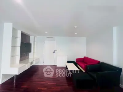 Spacious modern living room with stylish furniture and sleek wooden flooring