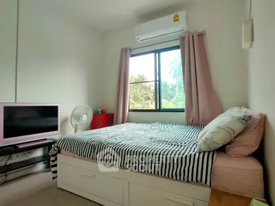 Cozy bedroom with large window and air conditioning, featuring a comfortable bed and modern decor.