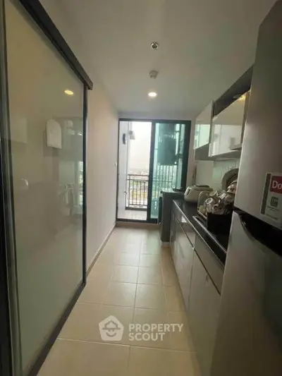 Modern kitchen with sleek cabinets and balcony view