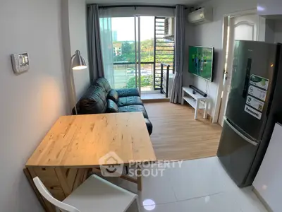 Modern living room with balcony view, featuring sleek furniture and contemporary design.
