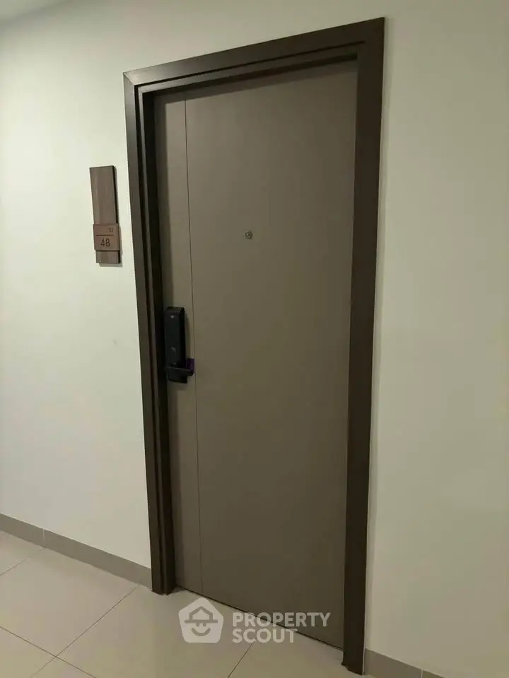 Modern apartment entrance with secure door and digital lock system.
