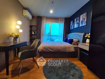 Luxurious bedroom with modern decor and city view, featuring elegant furniture and ambient lighting.