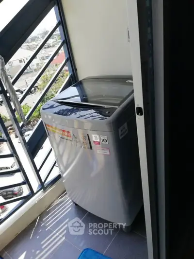 Compact balcony with modern washing machine and city view