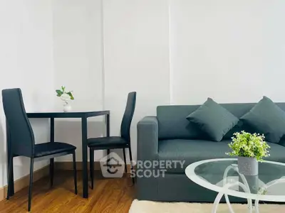 Modern living room with sleek furniture and stylish decor, featuring a cozy sofa and elegant dining set.