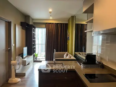 Modern living room with open kitchen and balcony view in a stylish apartment.