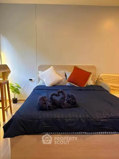 Cozy bedroom with stylish decor and comfortable bedding in modern apartment.