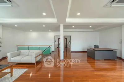 Spacious modern living room with wooden flooring and elegant furniture