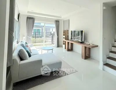 Spacious modern living room with large windows and stylish furniture
