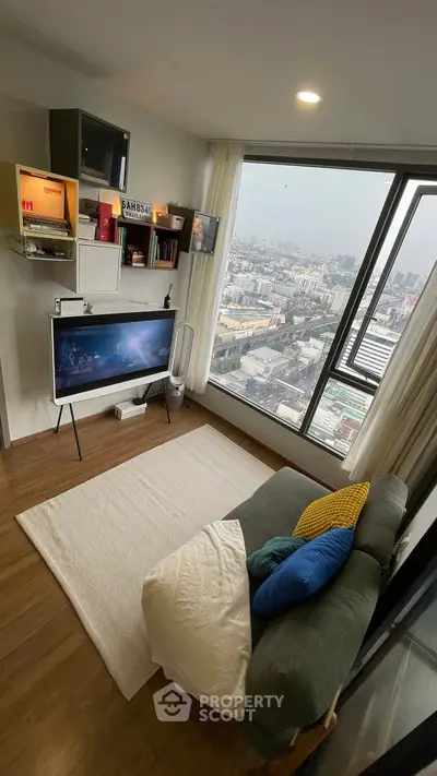 Modern living room with panoramic city view, stylish decor, and cozy seating area.