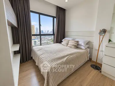 Modern bedroom with city view, cozy decor, and ample natural light.