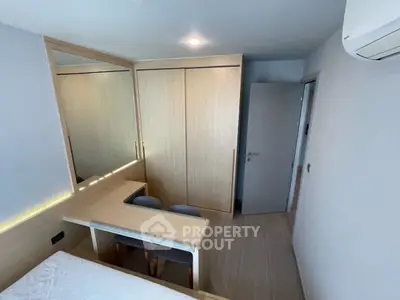 Modern bedroom with built-in wardrobe and compact study area