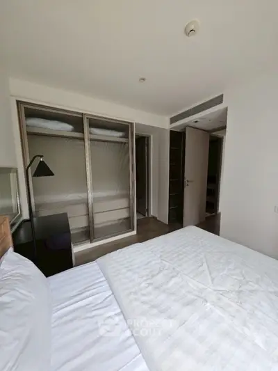 Cozy bedroom with modern design and built-in wardrobe