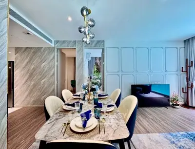 Luxurious dining area with elegant marble table and modern decor in a stylish apartment.