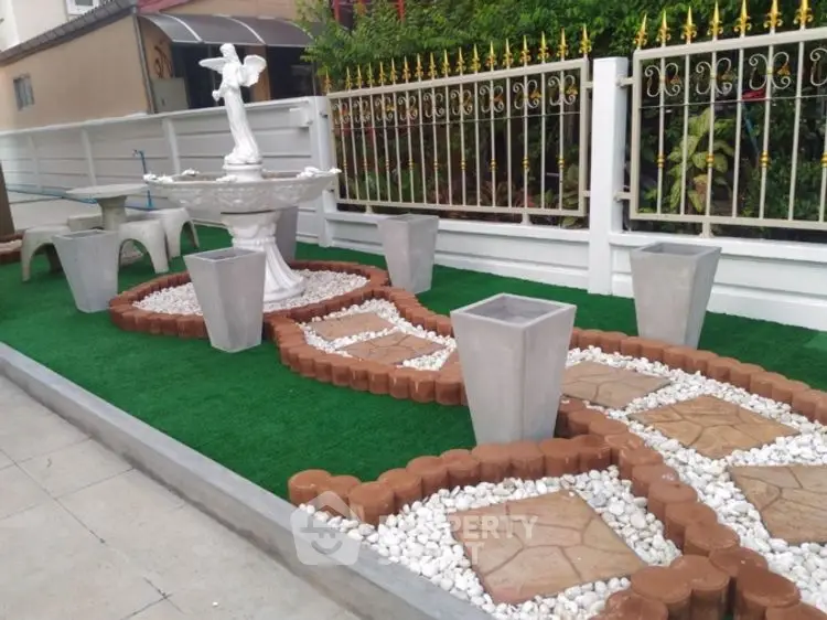 Charming garden with decorative pathway and elegant fountain feature.