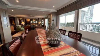 Spacious living and dining area with large windows and city view, featuring elegant decor and ample natural light.