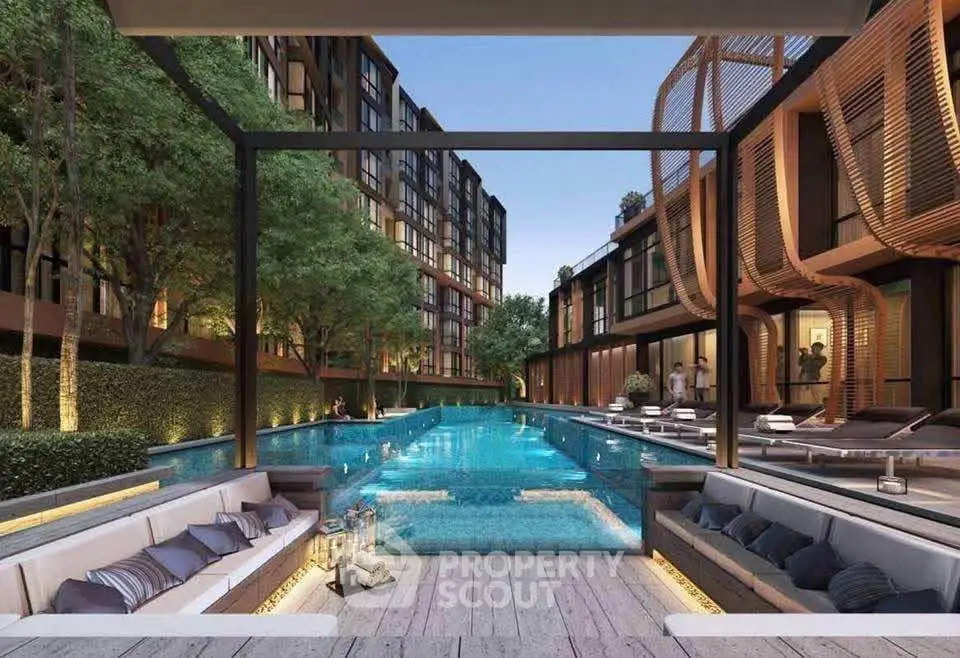Luxurious modern apartment complex with stunning pool and stylish outdoor seating area.