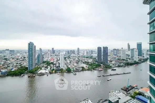 Stunning cityscape view from high-rise building overlooking river and skyline.