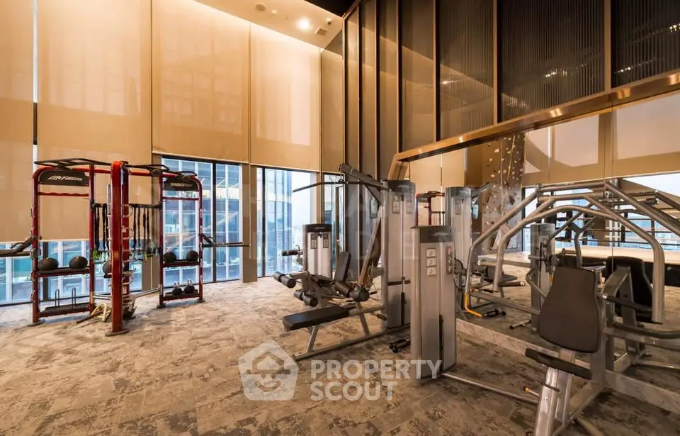 Luxurious high-rise gym with modern fitness equipment and panoramic city views.