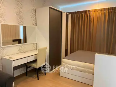 Cozy bedroom with modern furniture and ample storage space in a stylish apartment.