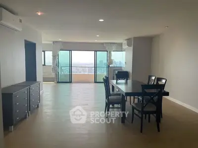 Spacious dining area with city view and large balcony access