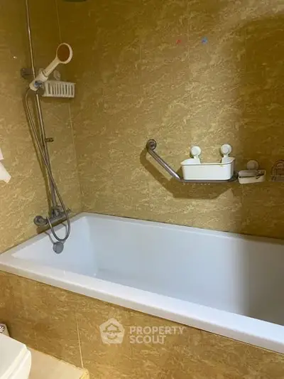 Luxurious bathroom with elegant bathtub and modern fixtures in a stylish real estate property.