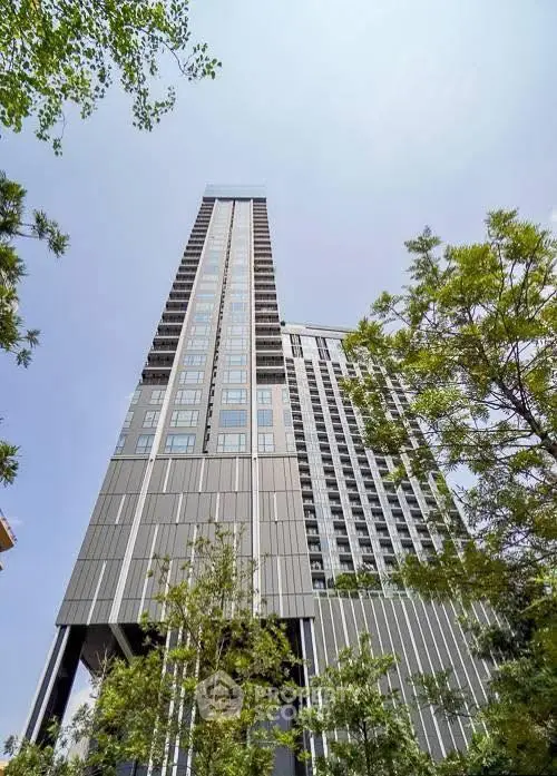 Stunning modern high-rise building with sleek design and lush greenery