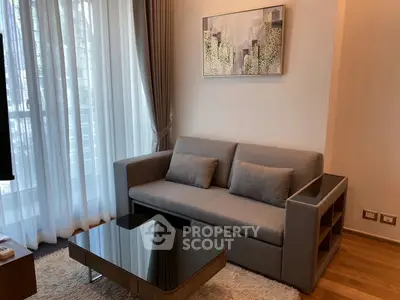 Modern living room with stylish gray sofa and elegant decor in a cozy apartment setting.