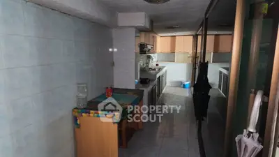 Spacious kitchen with closed layout and ample storage in a modern apartment.