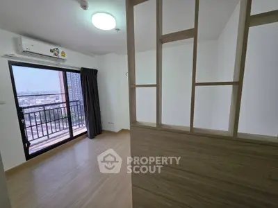 Modern apartment with balcony and city view, featuring sleek wooden partition and air conditioning.