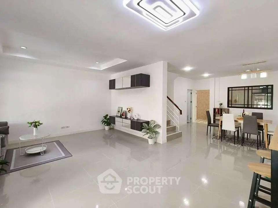 Spacious modern living and dining area with sleek design and ample natural light.