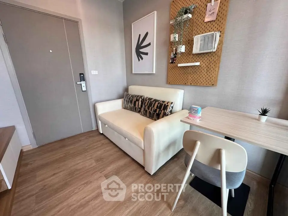 Cozy modern living room with stylish decor and comfortable seating in a compact space.
