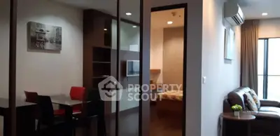 Modern apartment interior with open living and dining area, featuring stylish furniture and natural light.