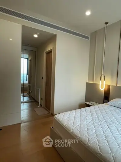 Modern bedroom with stylish lighting and wooden flooring